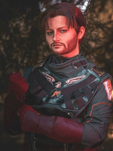 Person dressed as Soldier Boy standing with arms crossed in a wooded setting.