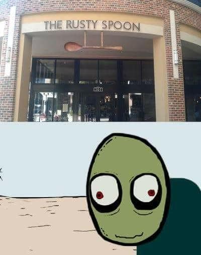 A storefront marked “THE RUSTY SPOON” appears above a cropped drawing of Salad Fingers against a pale, barren landscape.