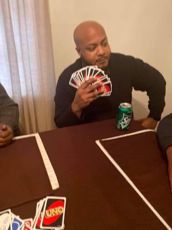 A man holding a huge hand of UNO cards