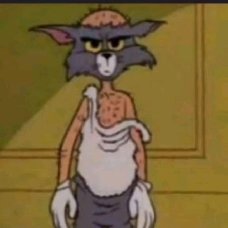 Tom with a shaved head looking unimpressed
