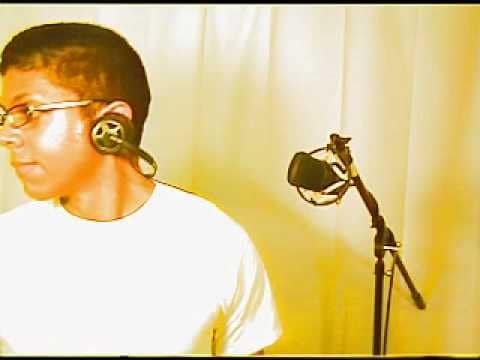 The Chocolate Rain performer turns away from a microphone, wearing glasses, headphones and a white T-shirt against pale curtains.